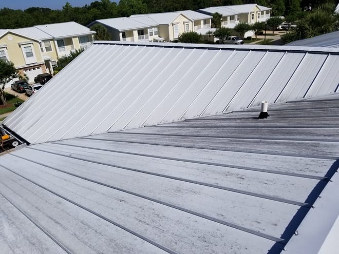 DPI pressure washing a metal roof in Tampa Bay area
