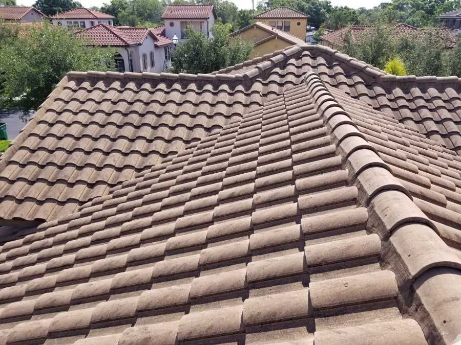 DPI pressure washing cleaning tile roofs in Tampa Bay area