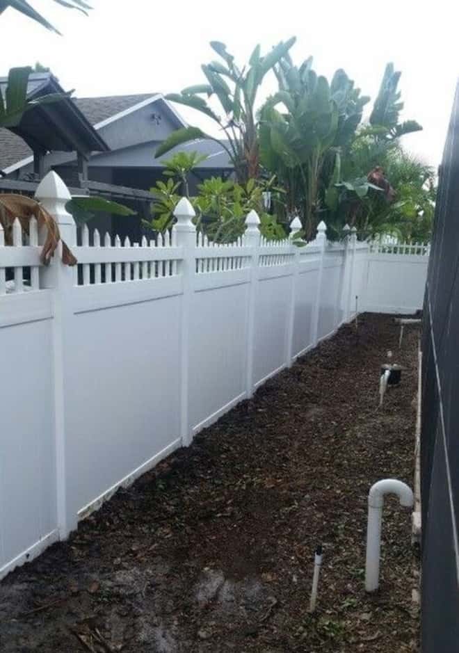 after pressure washing vinyl fence outside view