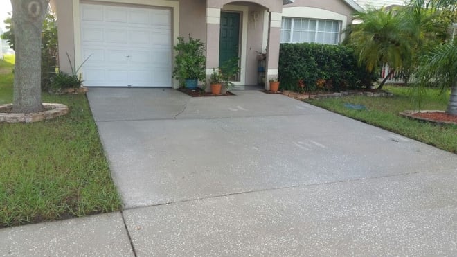 DPI pressure washing driveway after cleaning