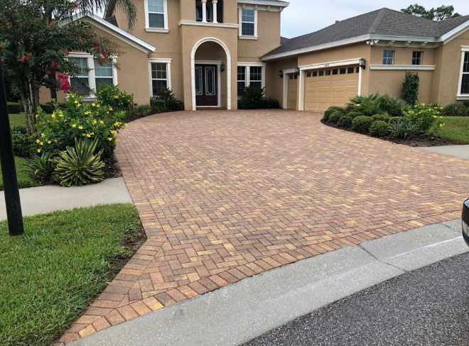 DPI Pressure Washing - a clean driveway in front of a house
