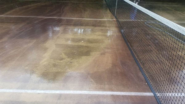 Tommy's tennis court before pressure washing