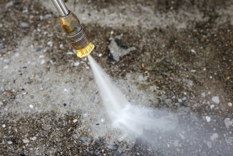 pressure cleaning mold from a concrete surface